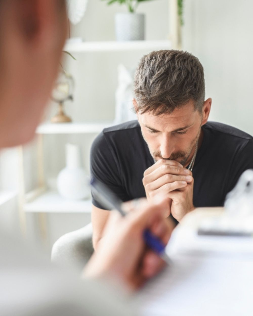 An adult client meeting privately with a licensed Royce Recovery therapist